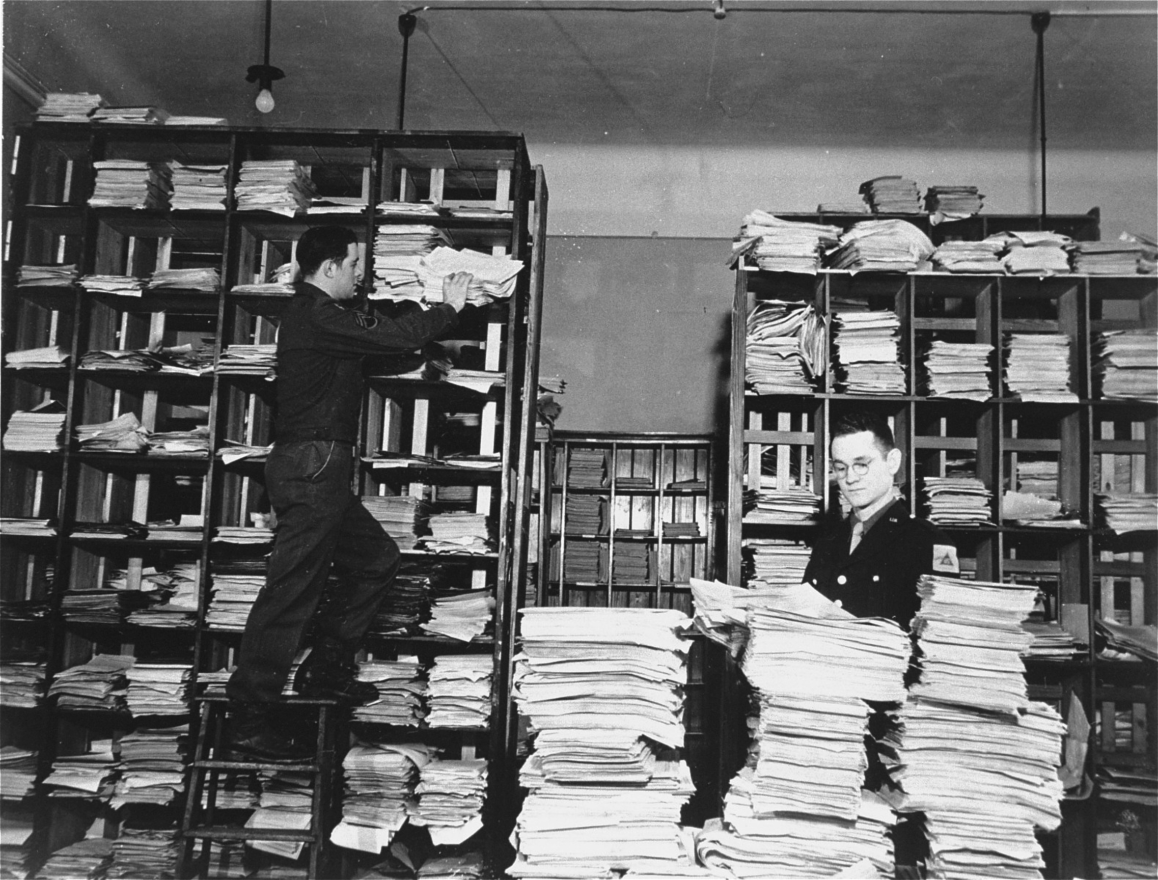 U.S. Army clerks with evidence collected for the Nuremberg trials. (Photo credit: Charles Alexander)